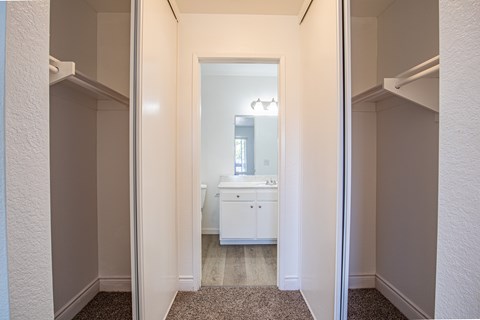 A white bathroom with a sink and mirror.