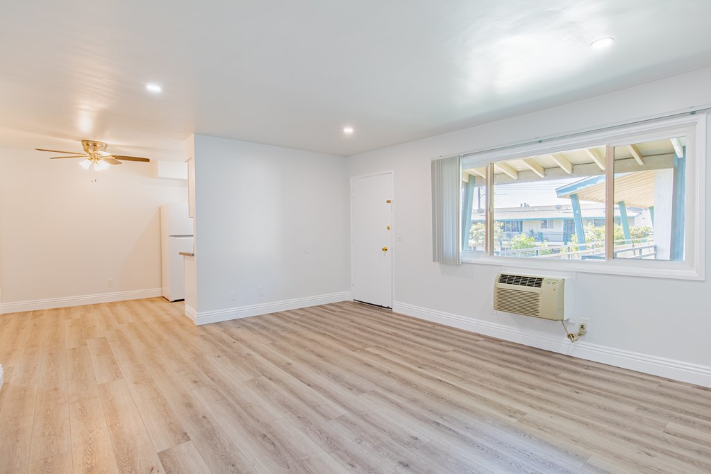 A room with a window and a ceiling fan.