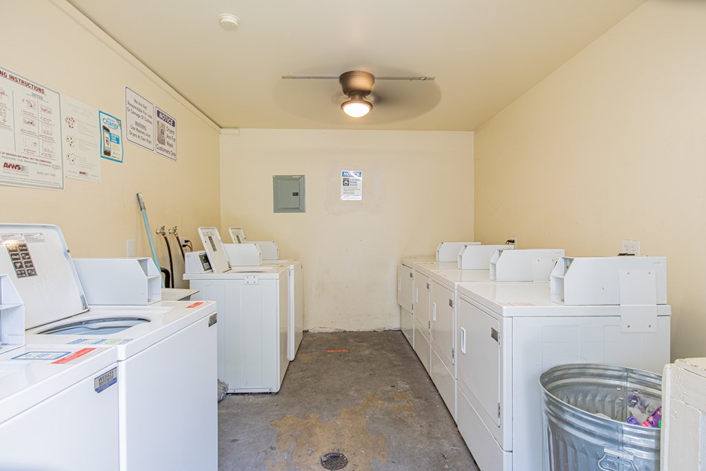 A laundry room with washers and dryers.