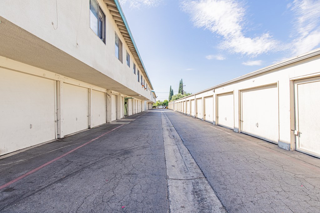 A long, empty road with white walls on either side.