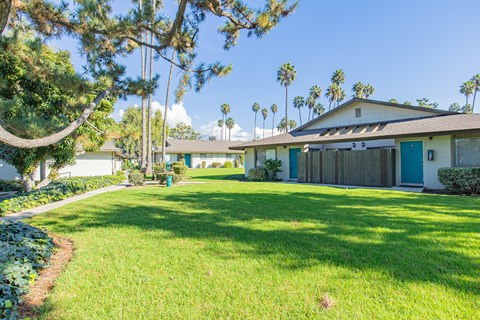 A house with a blue door and a green lawn.