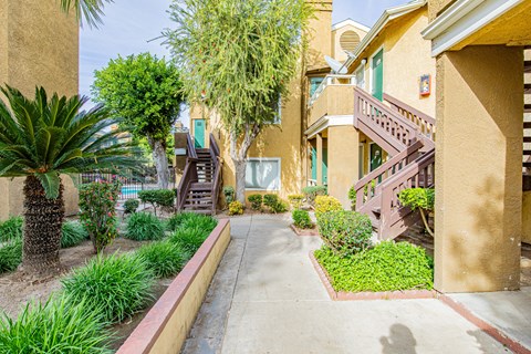 A pathway leads to a building with a green door.