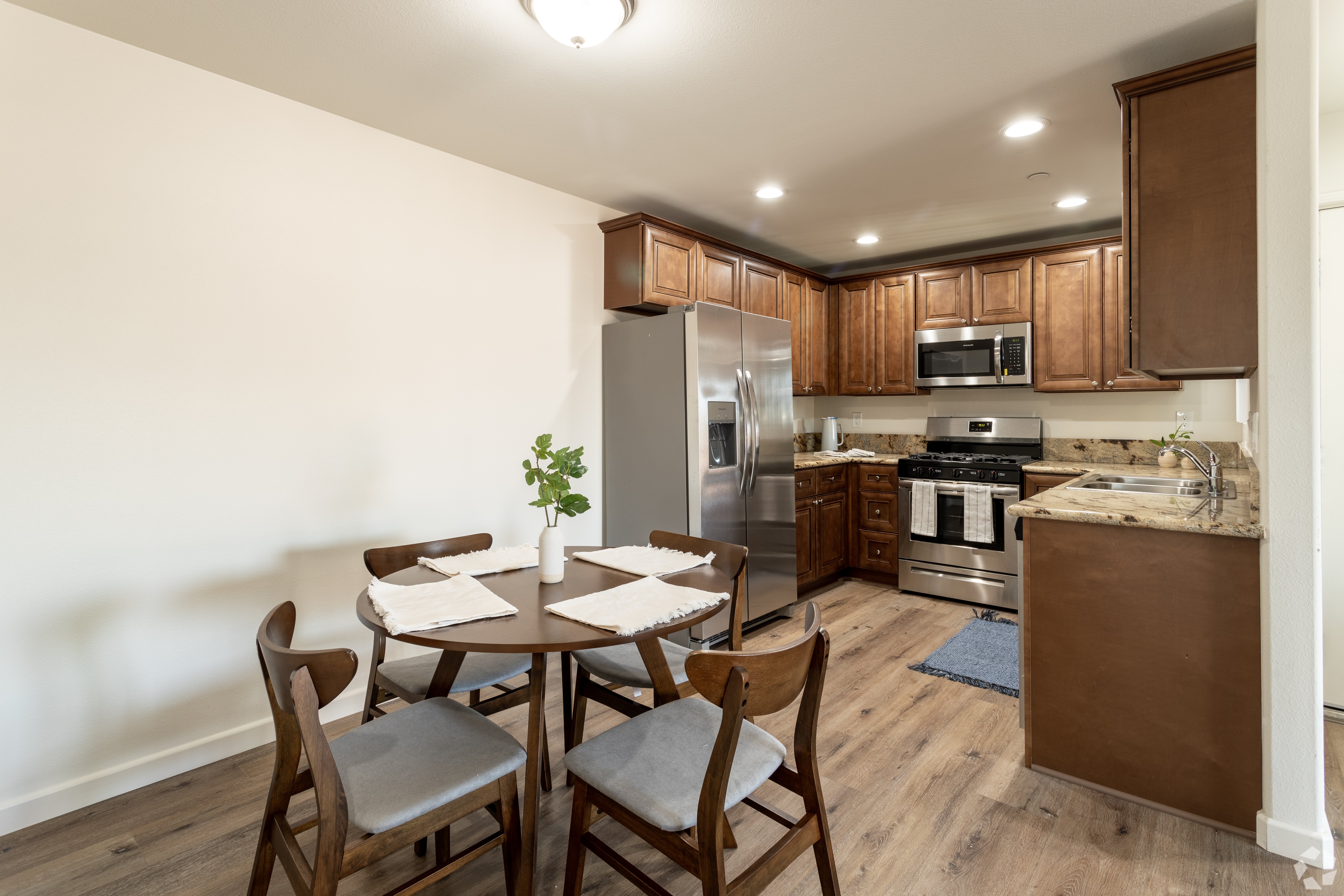 A kitchen with a table and chairs.