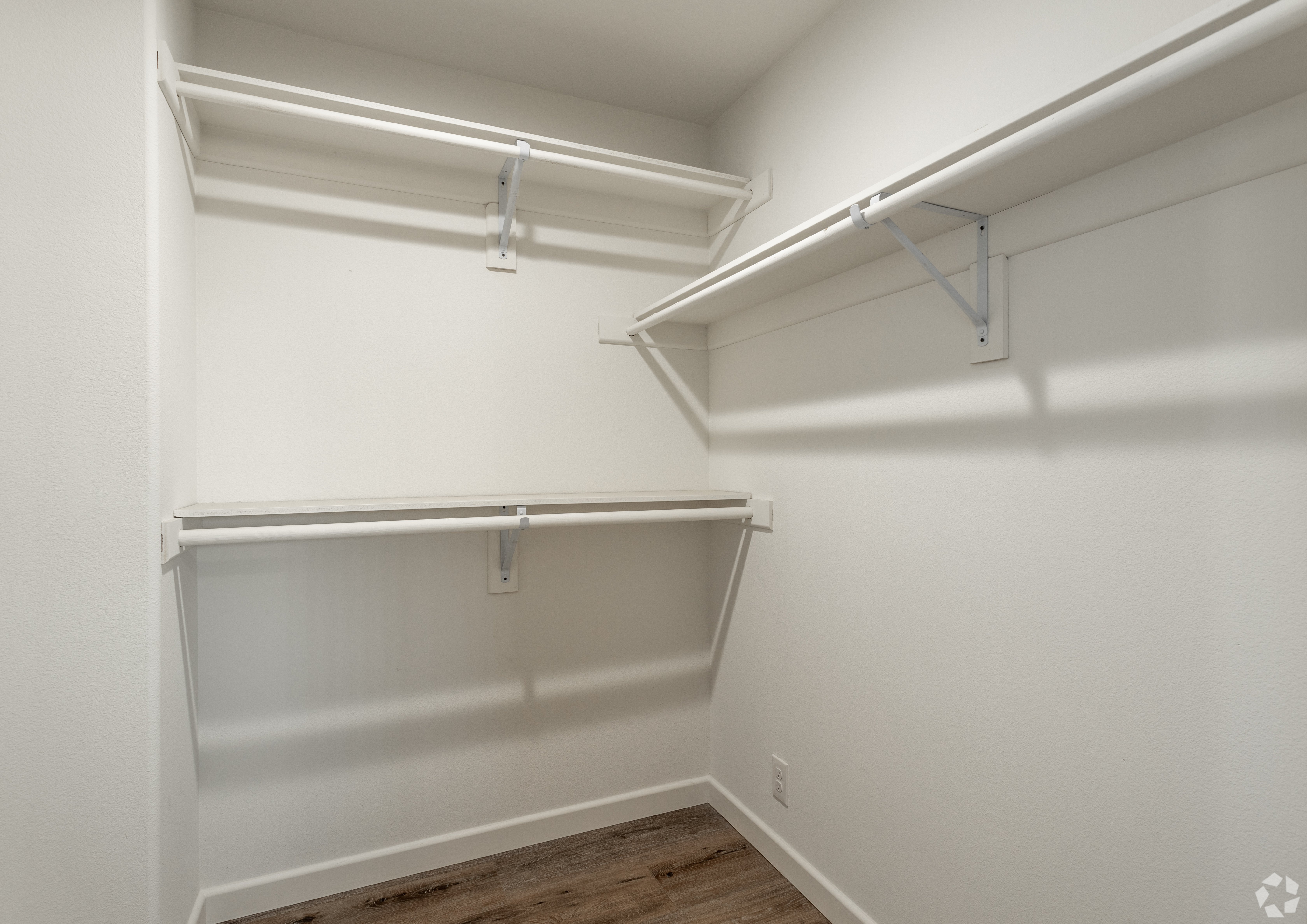 Empty white shelves in a room.