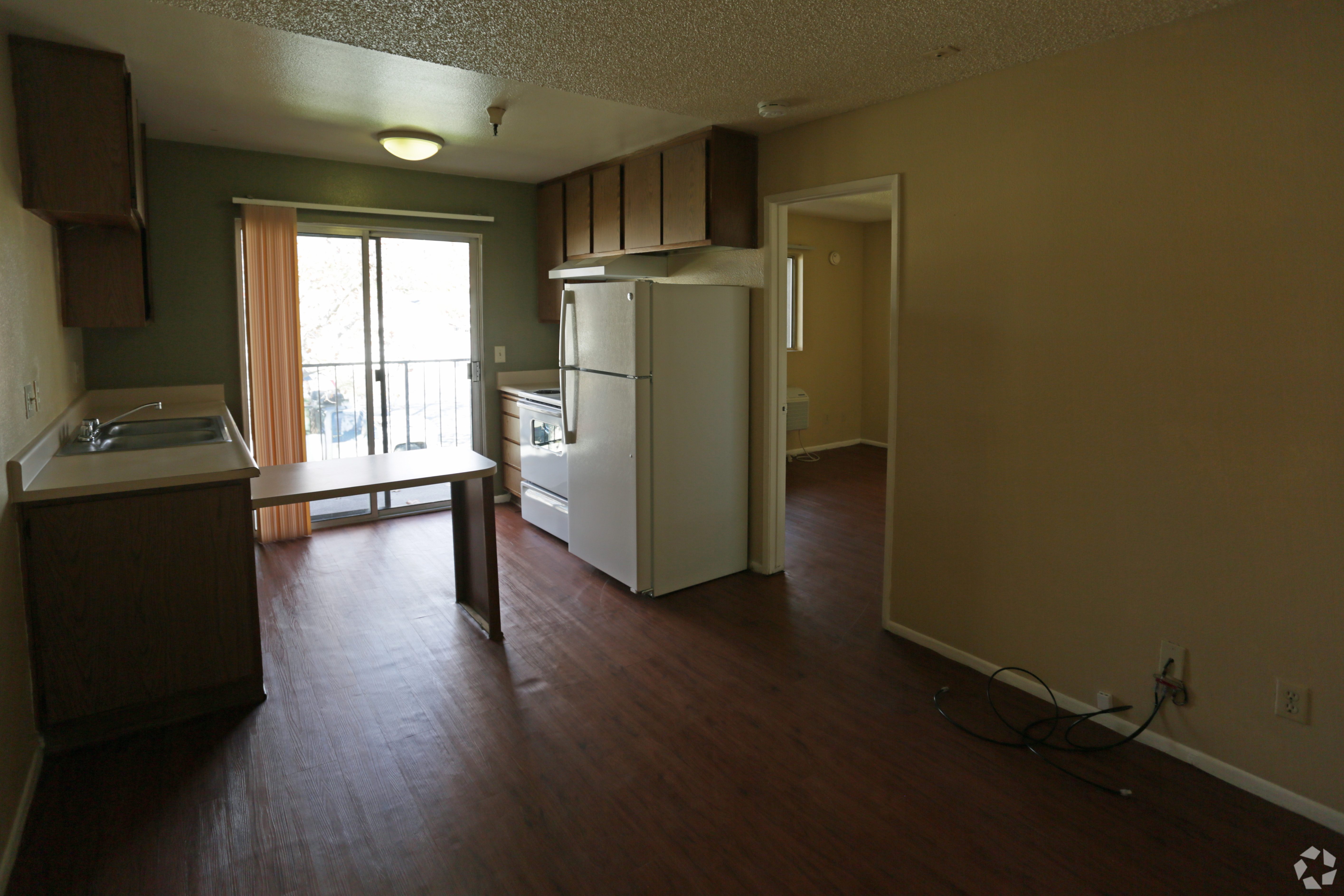 A kitchen with a refrigerator and a counter.