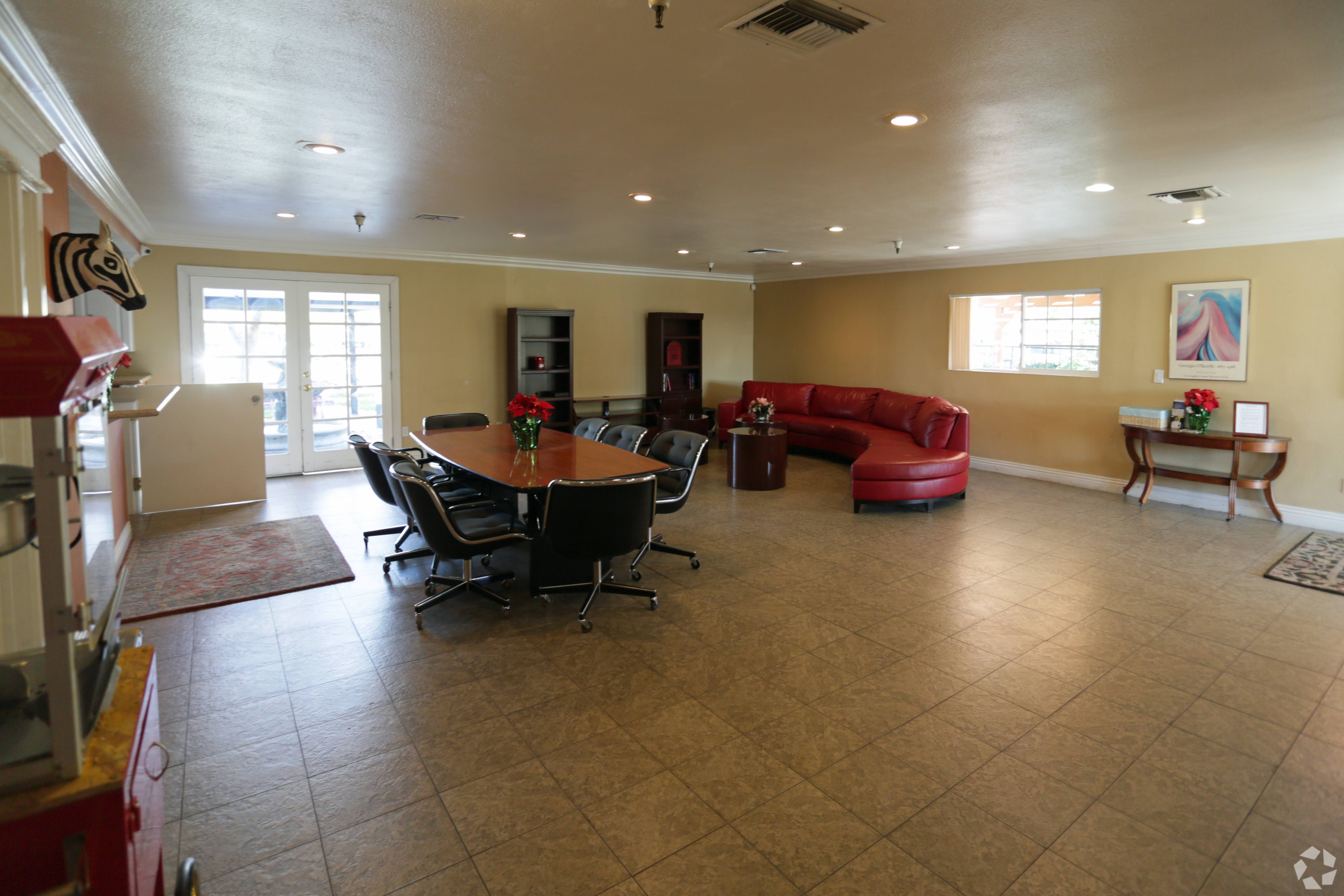 A living room with a dining table and chairs.
