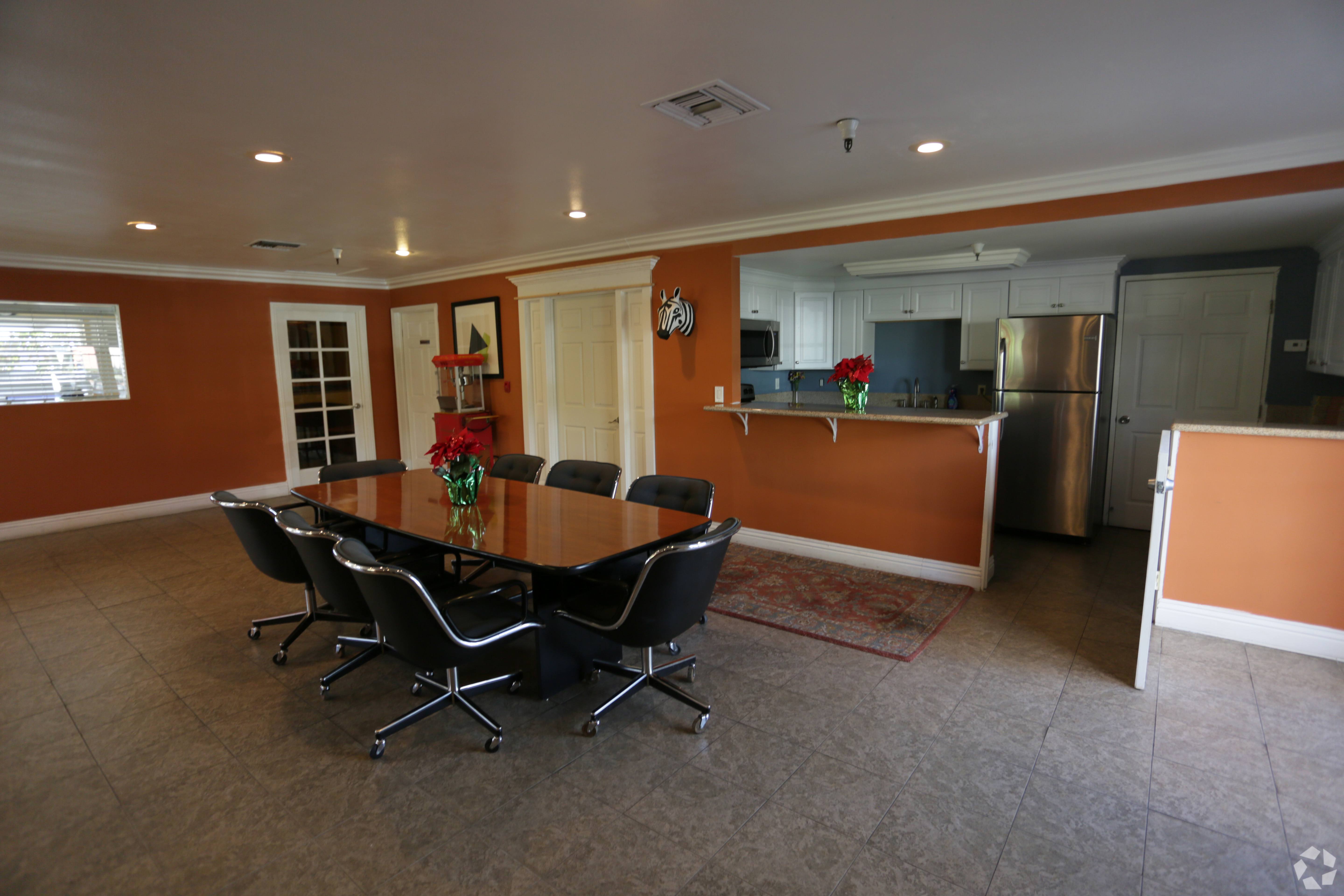 A conference room with a table and chairs.