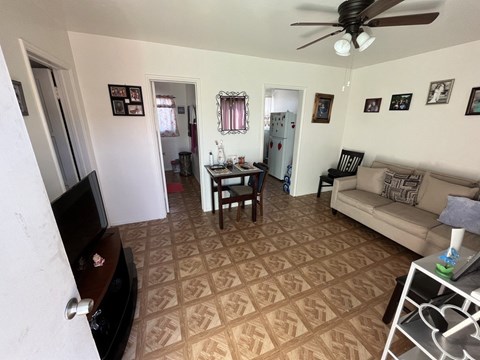 A living room with a brown patterned carpet.