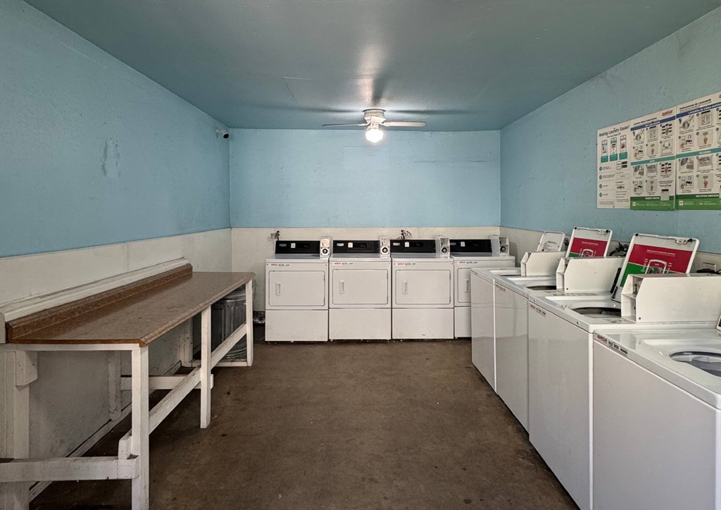 A clean, white-appointed room with a blue wall and a white table.