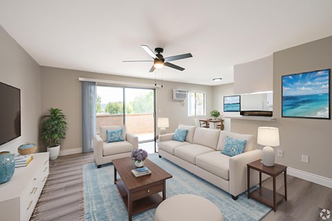 A living room with a couch, a coffee table, and a ceiling fan.