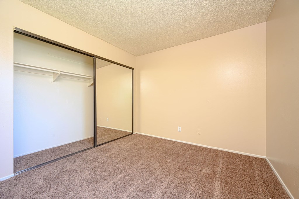 a bedroom with a closet and a window at Oak Terrace Senior Apts, Hemet, 92543