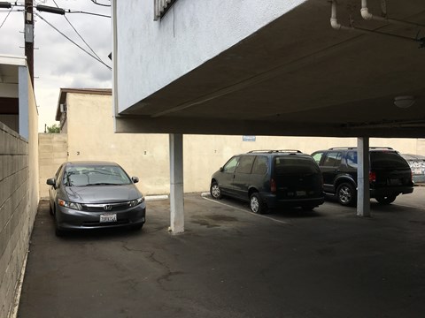 A black Honda Civic is parked in a parking lot.