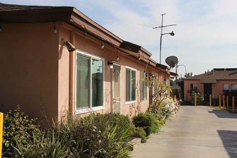 A long building with a satellite dish on top.