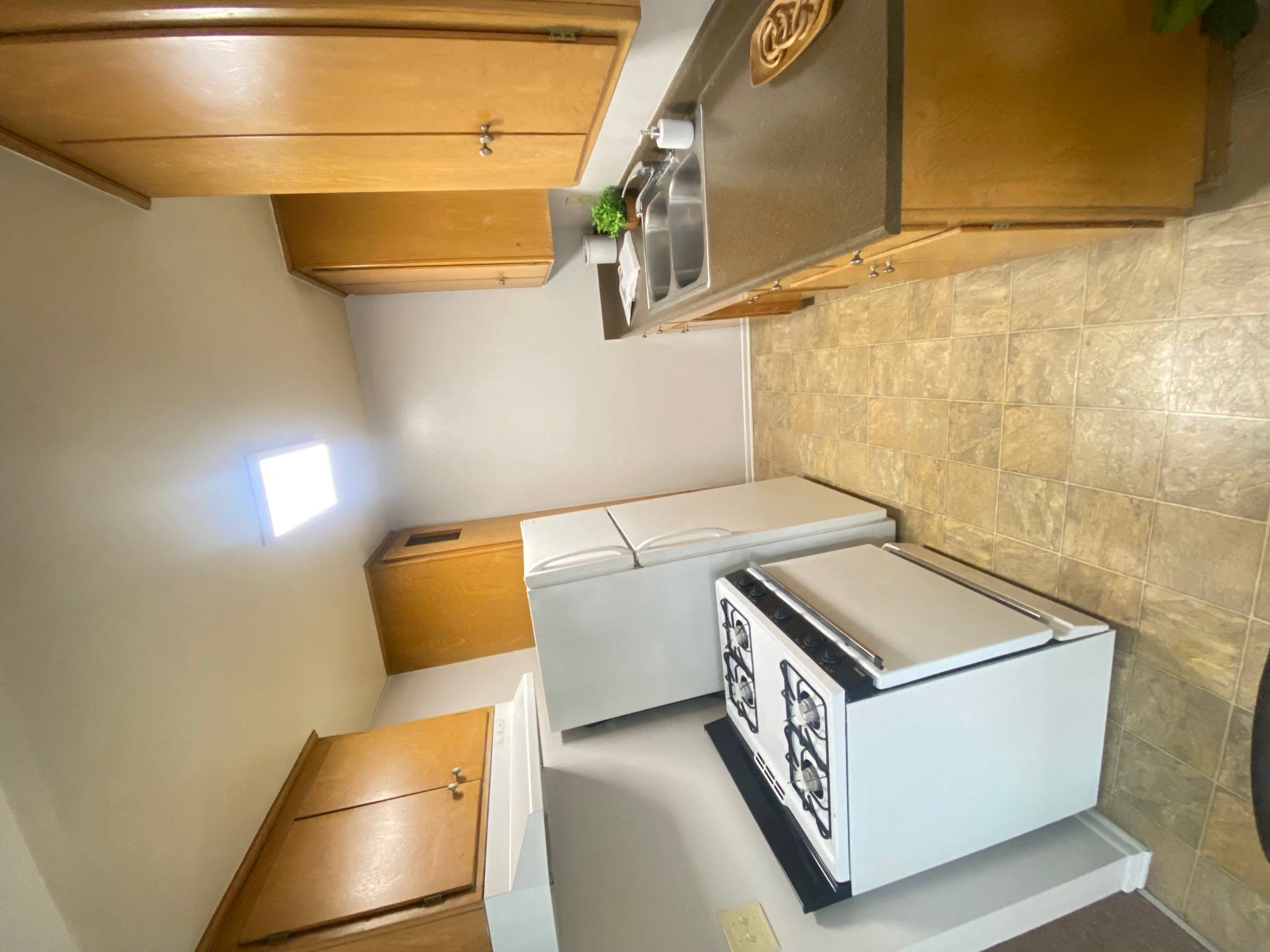 a small kitchen with two washes and a stove at Bowles Apts, California, 91702