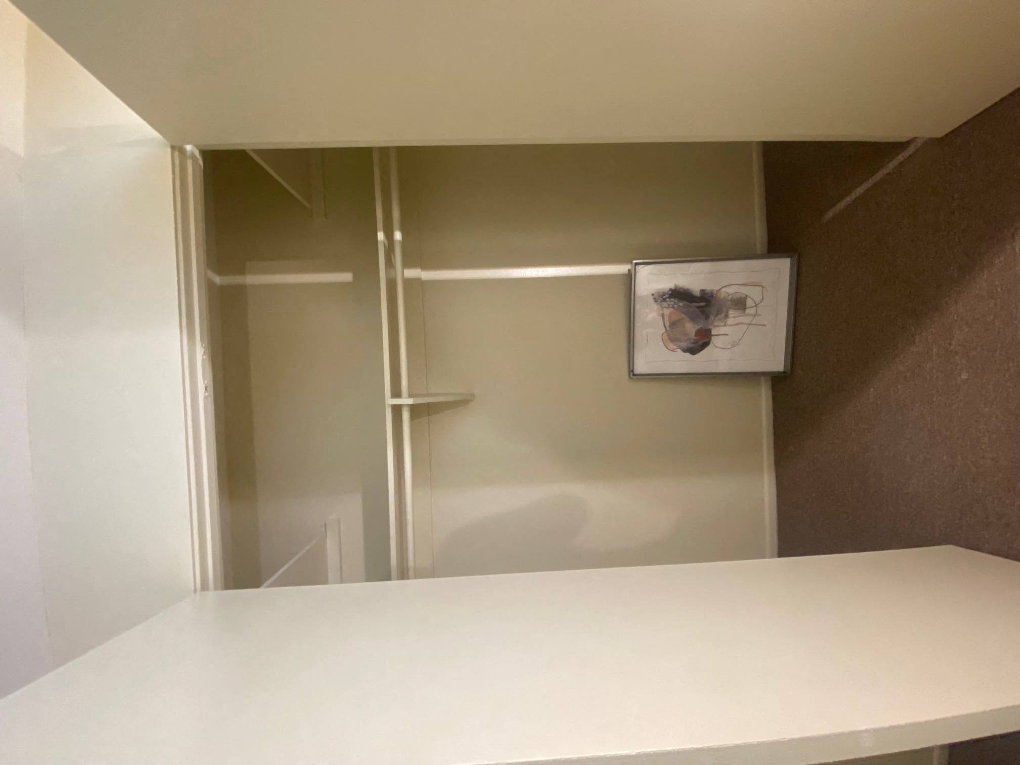 a white kitchen with a white counter top and a refrigerator at Bowles Apts, California