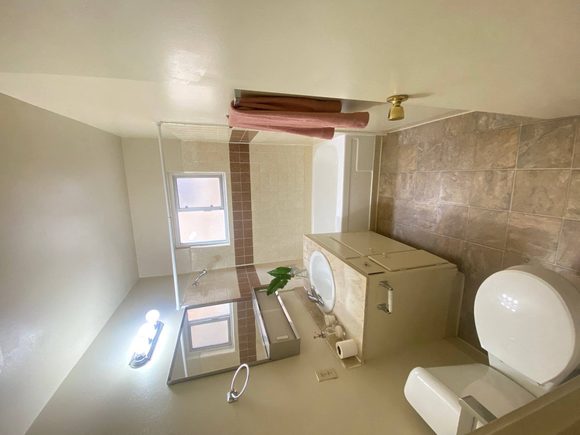 a small bathroom with a toilet and a shower at Bowles Apts, Azusa