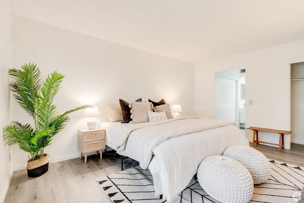 a bedroom with a bed and a potted plant at Alosta Place, Azusa, CA