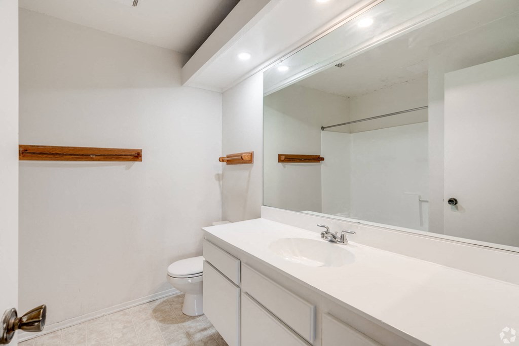 a bathroom with a large mirror and a sink and a toilet at Alosta Place, Azusa, 91702