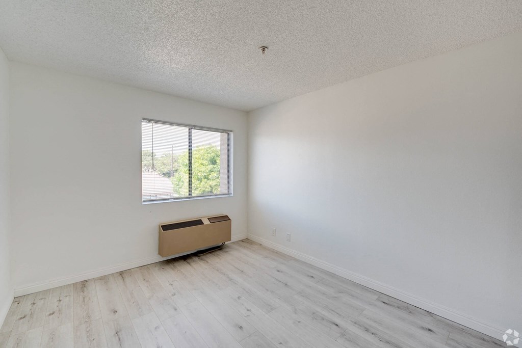 an empty room with white walls and a window an empty room with white walls and a window at Huntington Terrace North Senior, California