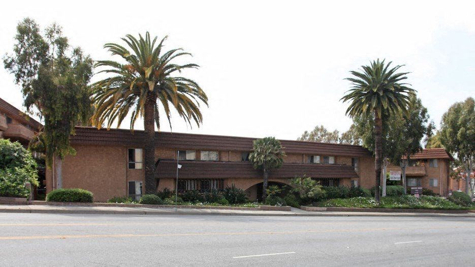 a brown building with palm trees in front of it at North View Terrace, Montebello, 90640