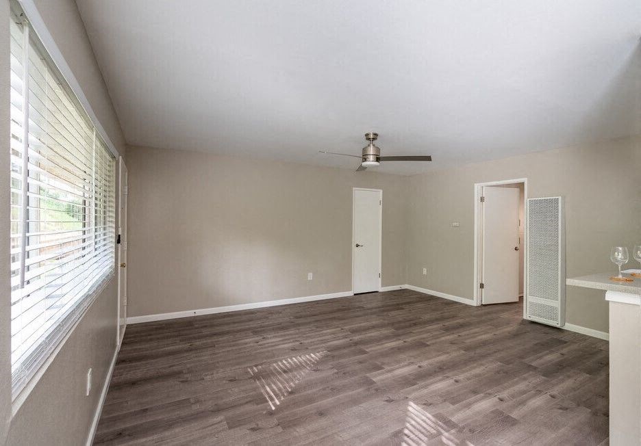 an empty living room with a ceiling fan and a window at North View Terrace, California