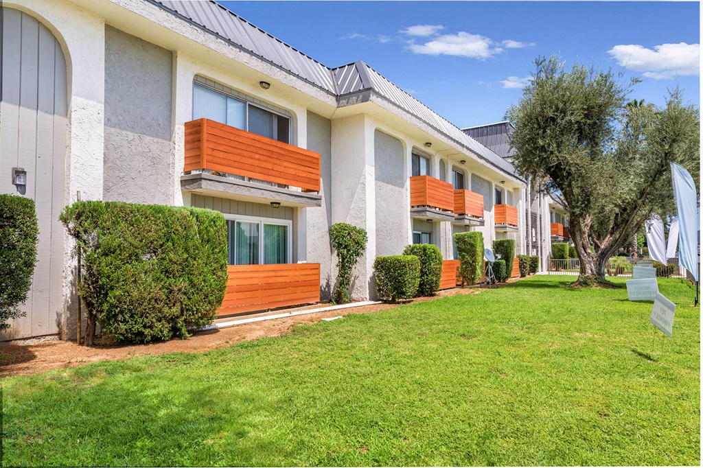 a building with a lawn and trees in front of it at Sunnymead Apts Apartments, Moreno Valley, CA, 92553