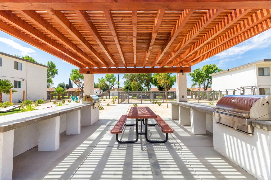 a patio with a picnic table and a grill at Sunnymead Apts Apartments, Moreno Valley, 92553