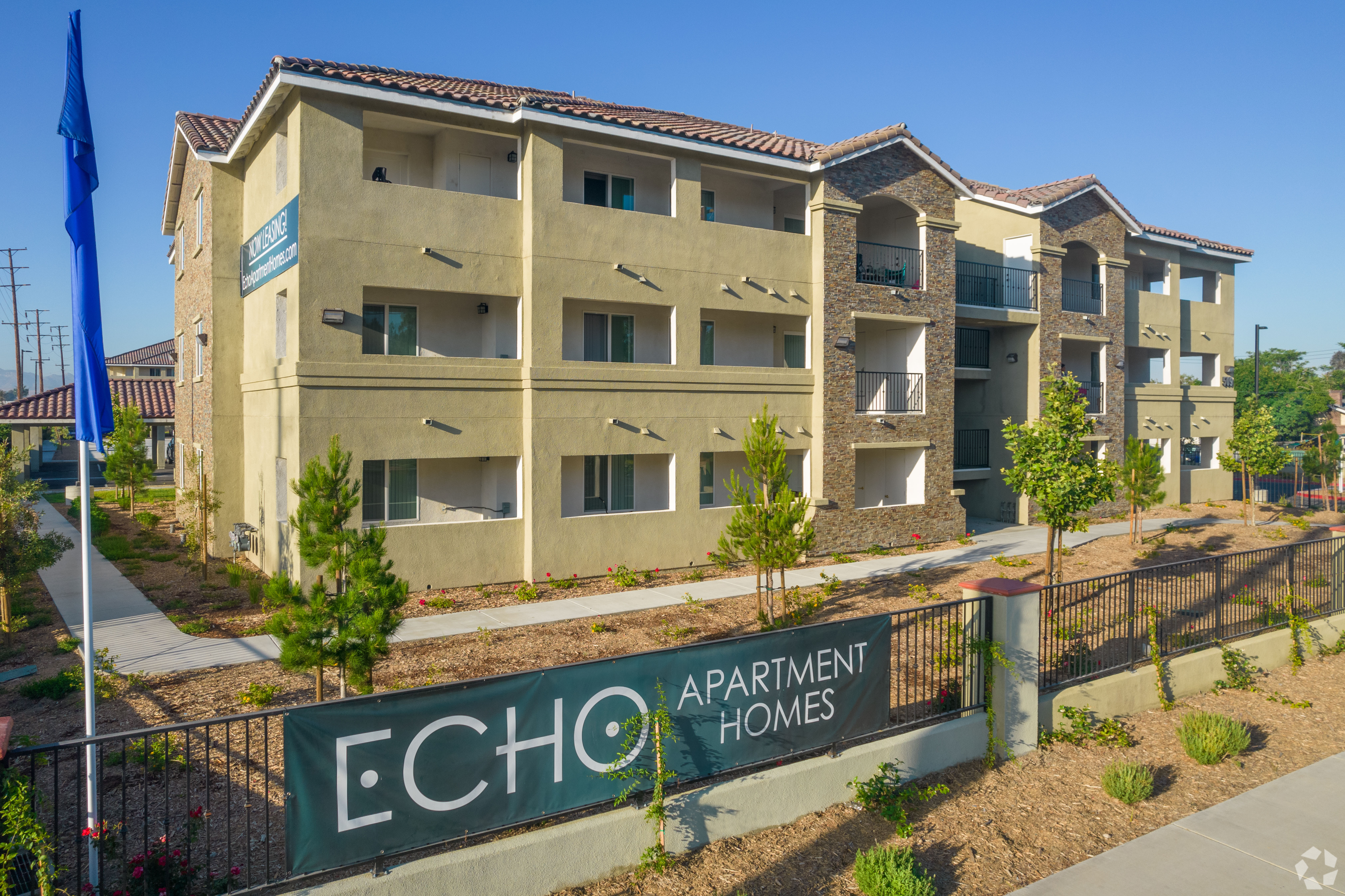 Apartment homes with a sign that says ECHO in front of it.