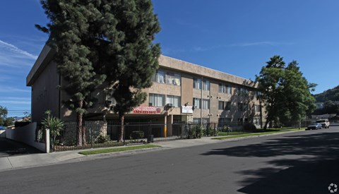 A building with a tree in front of it.