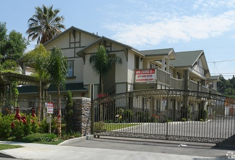 A gated community with a sign that says "New Home Open House".