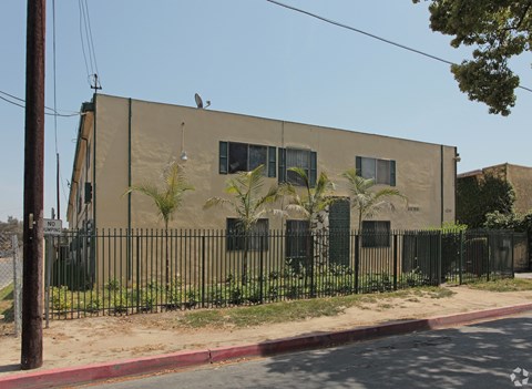 A building with a black fence and a bird on top.