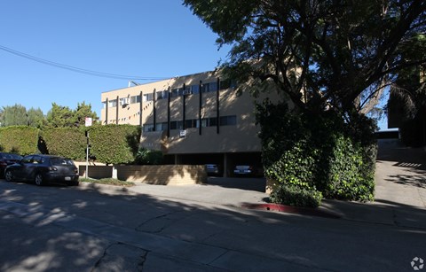 A car is parked on the left side of the street.