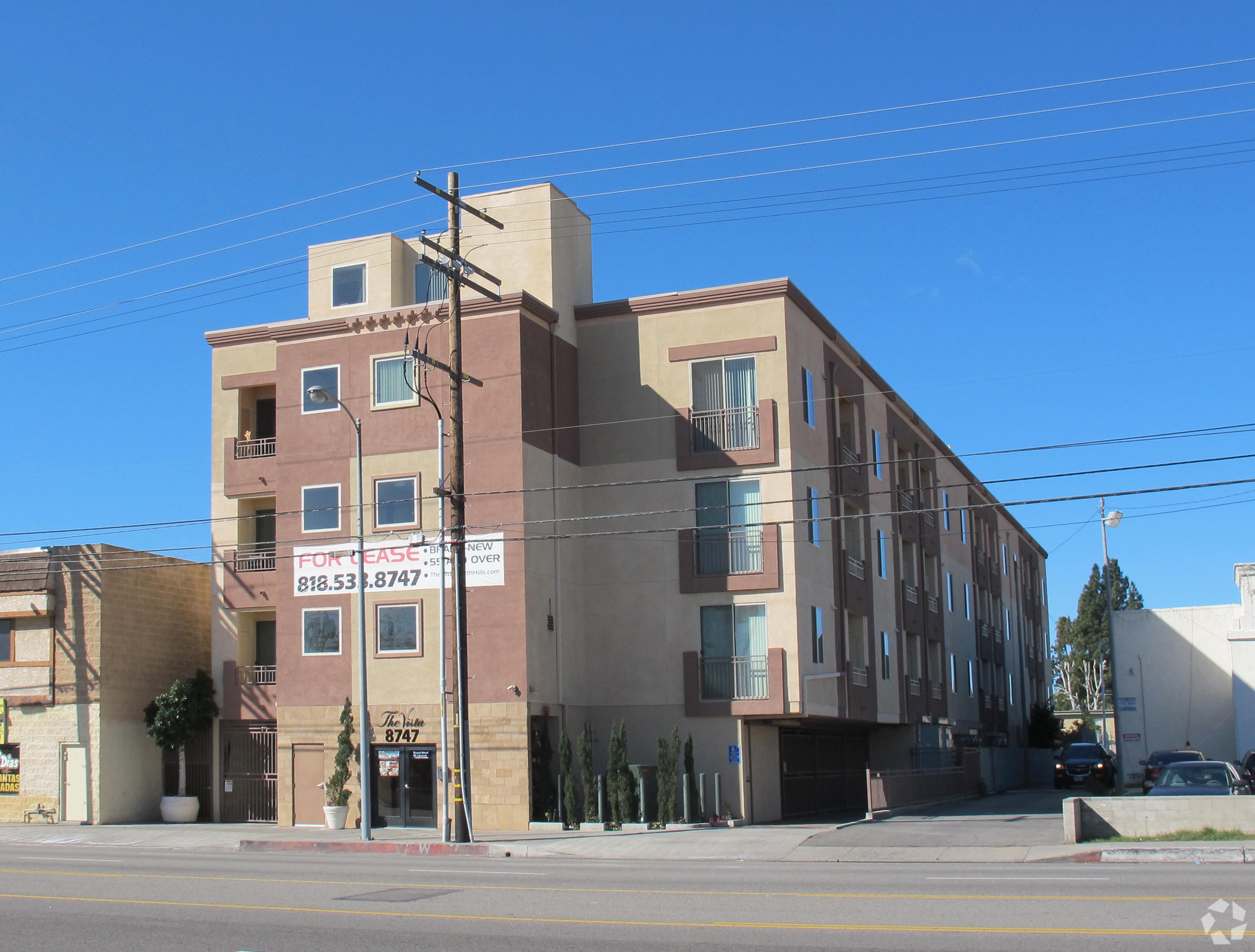 A building with a sign that reads "818.53.8747" is shown.