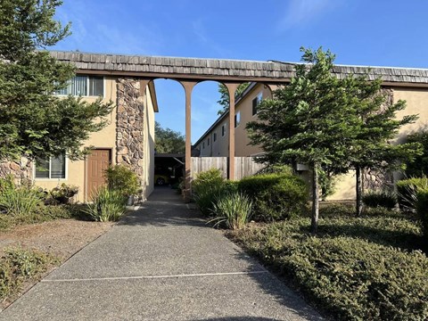 A stone building with a bridge-like structure above the entrance.