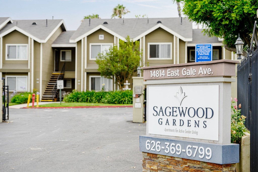 a sign in front of a row of houses