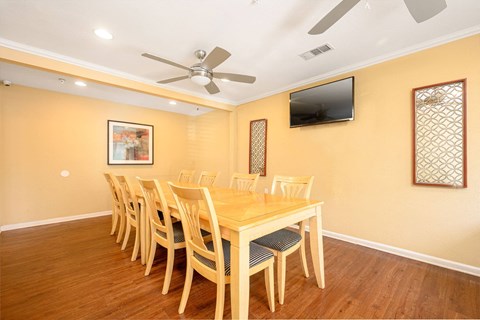 a dining room with a table and chairs and a flat screen tv at Sagewood Gardens Senior Apartments, Hacienda Heights, CA
