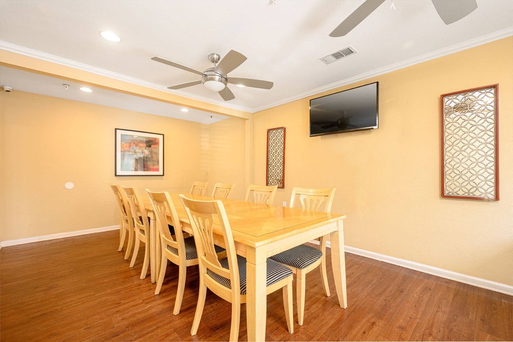 a dining room with a table and chairs and a flat screen tv a dining room with a table and chairs and a flat screen tv at Sagewood Gardens Senior Apartments, Hacienda Heights, CA