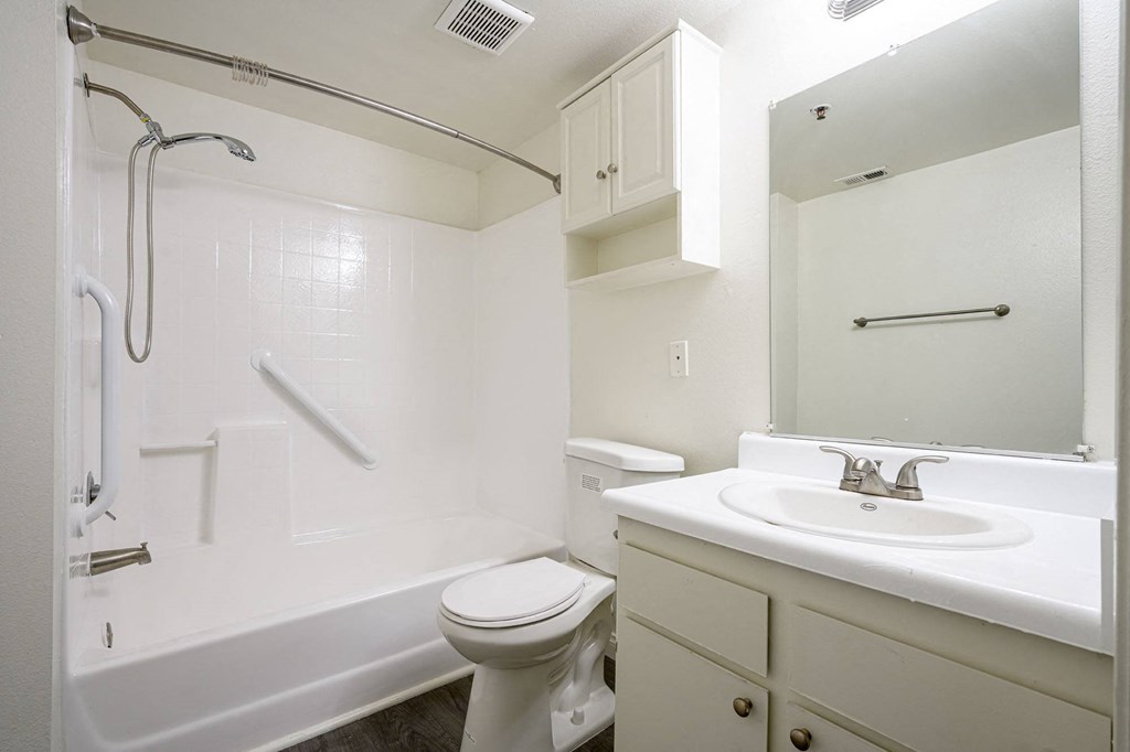 a bathroom with a bathtub toilet sink and mirror at Sagewood Gardens Senior Apartments, California, 91745