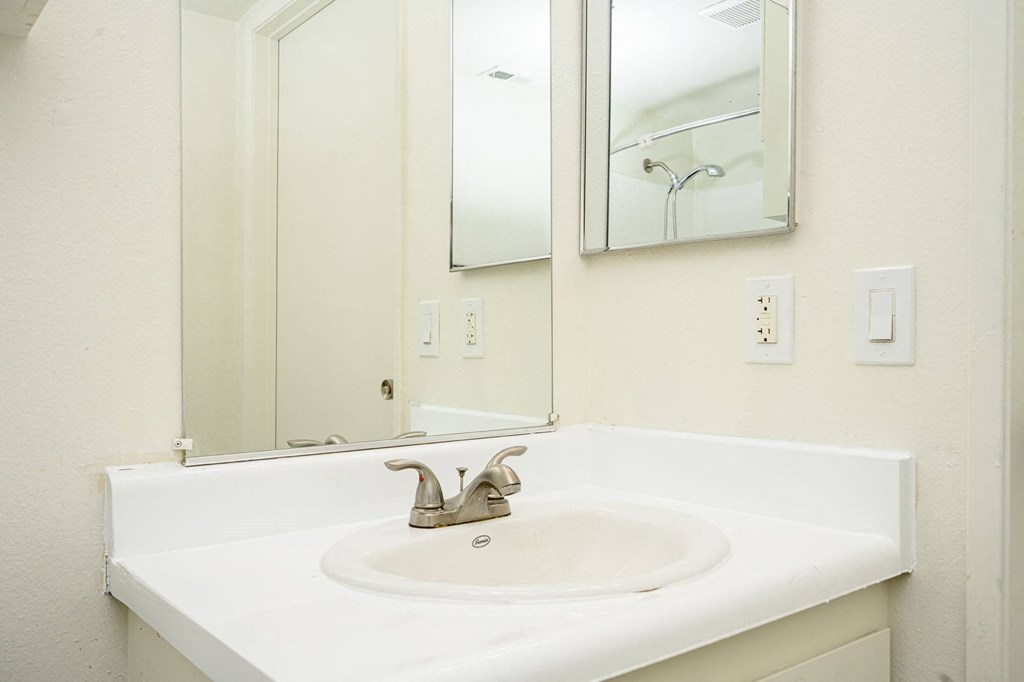 a bathroom with a sink and a mirror at Sagewood Gardens Senior Apartments, Hacienda Heights, 91745