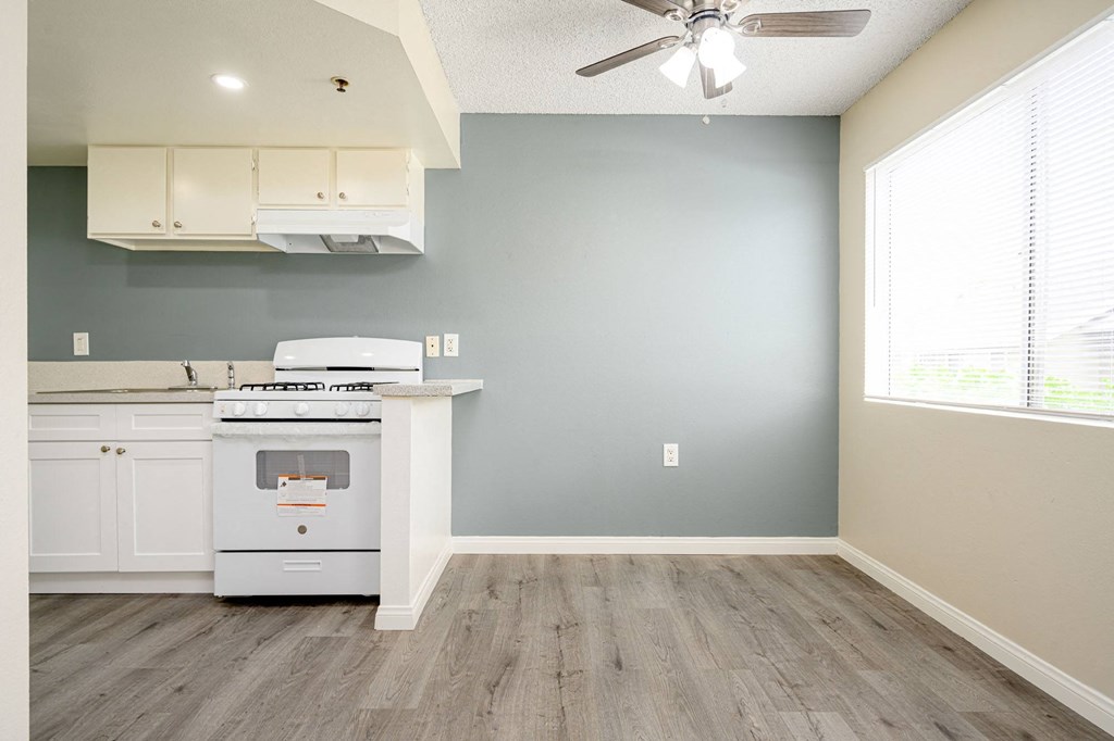 a kitchen with a stove and a ceiling fan at Sagewood Gardens Senior Apartments, Hacienda Heights