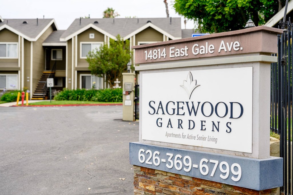 a sign in front of houses a sign in front of houses at Sagewood Gardens Senior Apartments, Hacienda Heights California