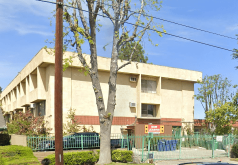 A building with a tree in front of it.