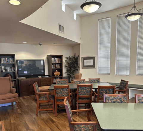 A room with a green table and chairs.