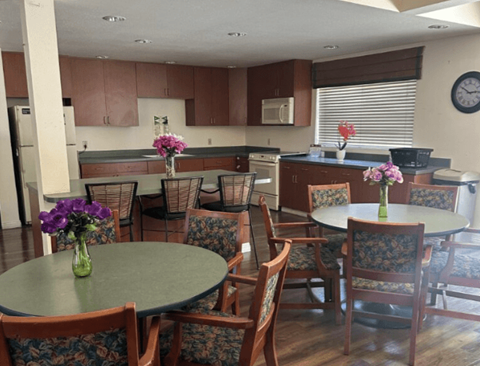 A kitchen with a table and chairs.