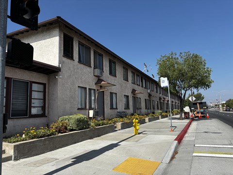 A street view of a building with a fire hydrant in front of it.