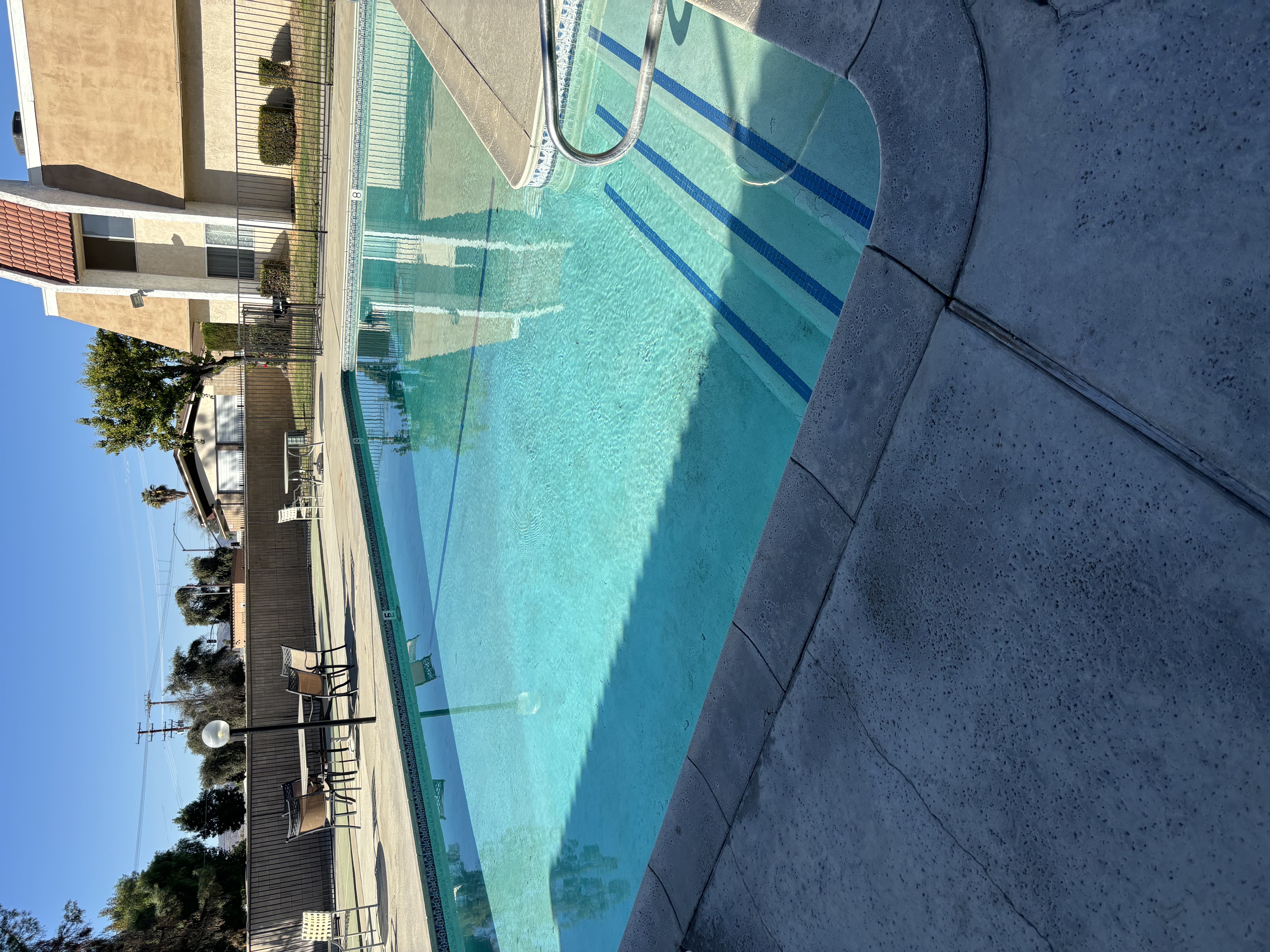 A swimming pool with a blue tinted water.