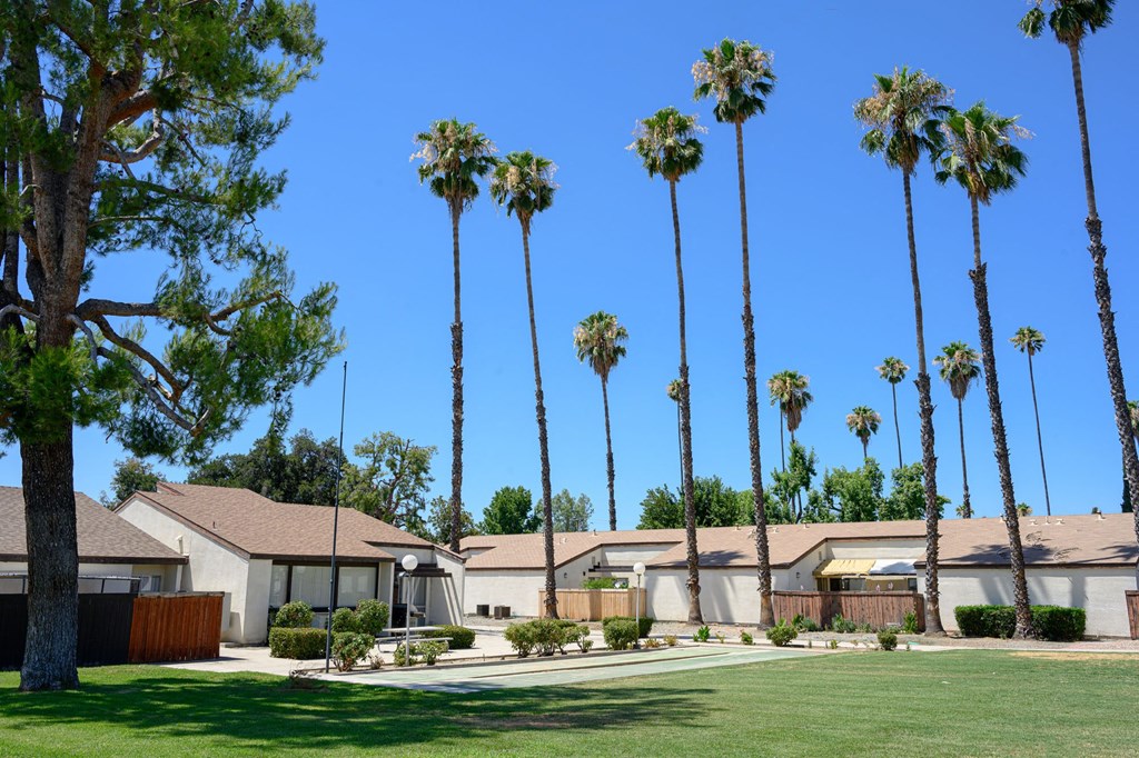 a row of houses with palm trees in the background at Villa Hemet, Hemet
