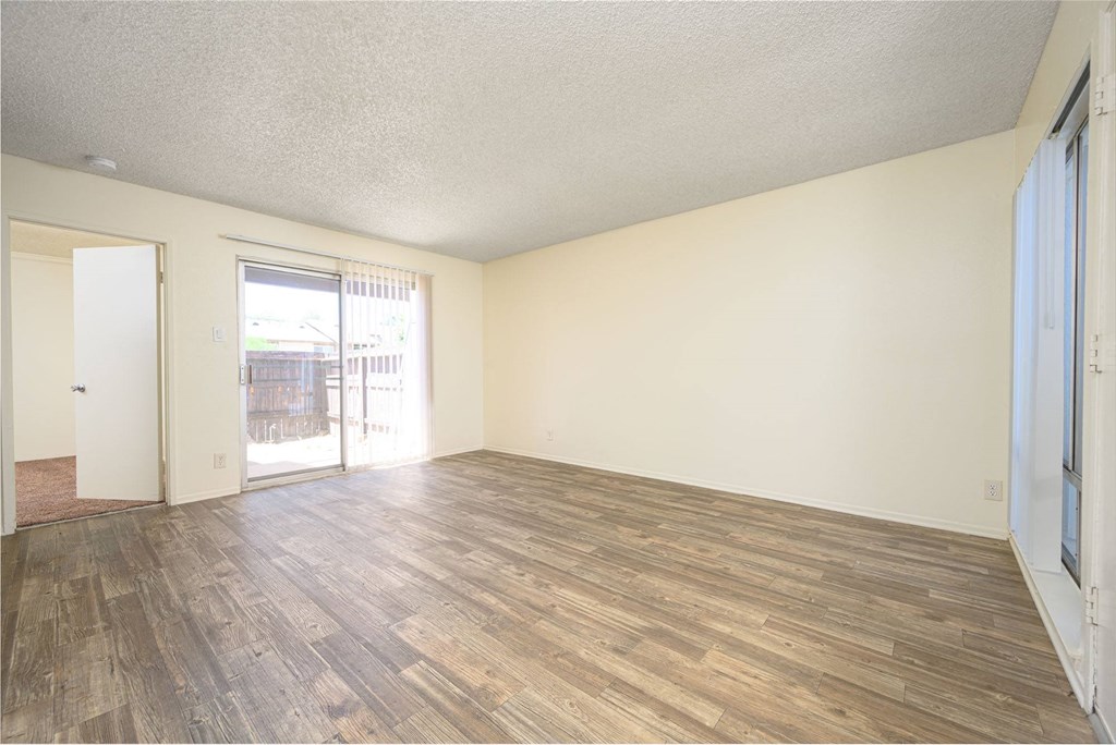 a bedroom with hardwood floors and white walls at Villa Hemet, California, 92543