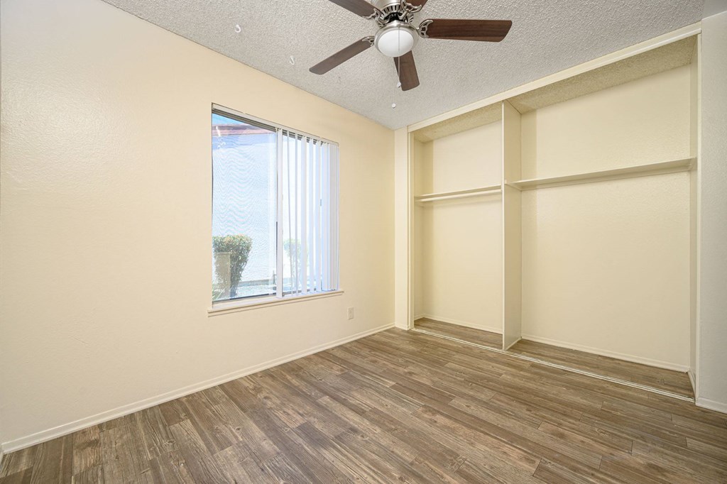 a bedroom with a large window and a ceiling fan at Villa Hemet, California