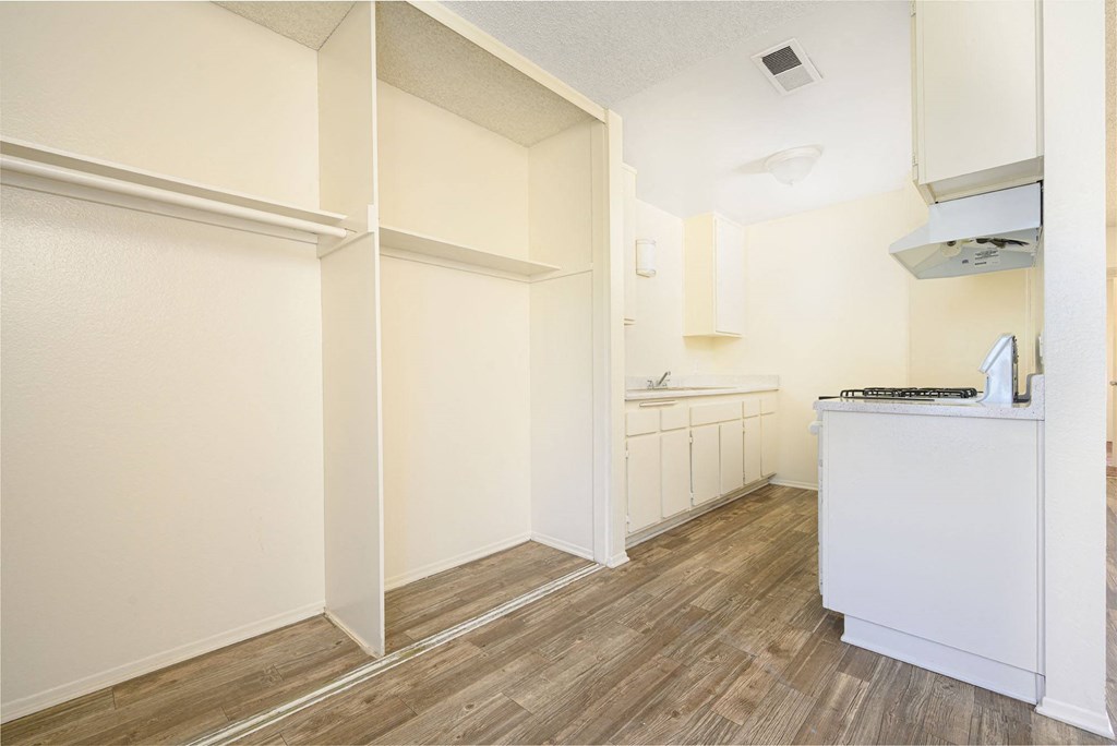 a kitchen with white walls and wood flooring at Villa Hemet, California